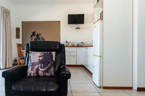 a black chair with a picture of a woman on it at Melkboomsdrift Guest House & Conference Centre in Vredendal