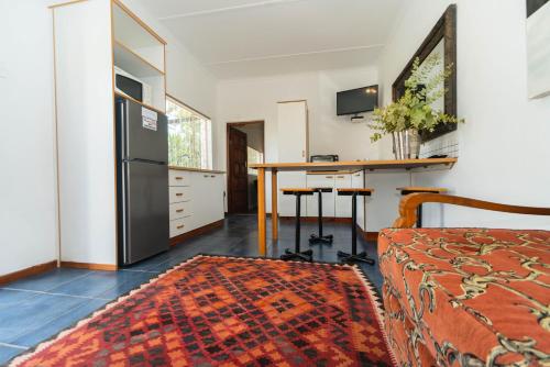 a kitchen and dining room with a table and a refrigerator at Melkboomsdrift Guest House & Conference Centre in Vredendal