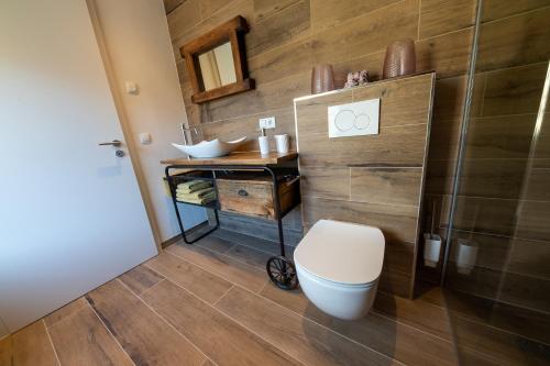 a bathroom with a toilet and a sink at Green & Breakfast Le Luxembourg in Niederpallen