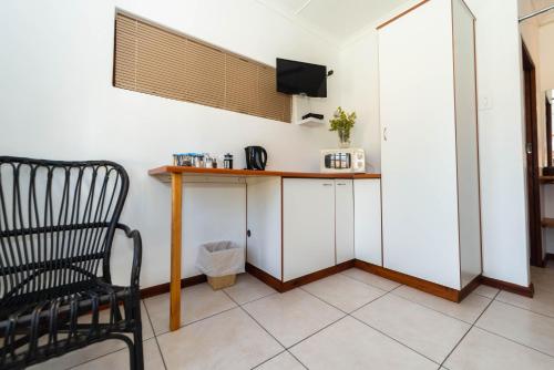a room with a table and a chair in a room at Melkboomsdrift Guest House & Conference Centre in Vredendal