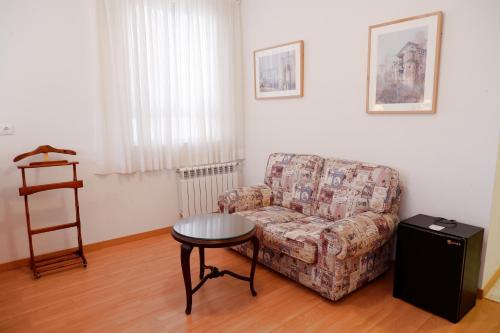 a living room with a couch and a table at Hotel Andalucia in Lanjarón