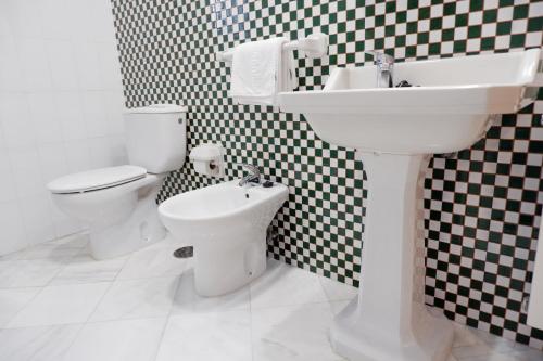 a bathroom with a sink and a toilet at Hotel Andalucia in Lanjarón