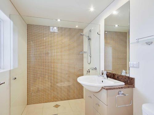 a bathroom with a sink and a shower at Carrington, 8 15 Government Road - spacious unit with air conditioning, lift, secure parking and close to town in Nelson Bay