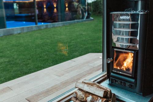 a wood stove in a window with a fire in it at Ferienhof A&B Wellness Villa 6 personen in Bullange
