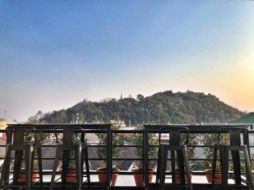 a group of chairs sitting on top of a balcony at DAAD FAH home and cafe in Phetchaburi