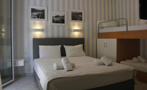a bedroom with a bed with two bunk beds at Aliki Studios in Parga
