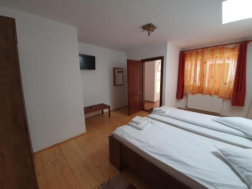a large bedroom with two beds and a window at Casa Terezia in Braşov