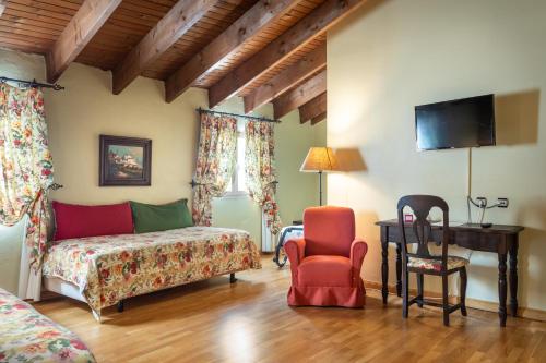a bedroom with a bed and a chair at Hotel Sao Joao De Deus by RIDAN Hotels in Elvas