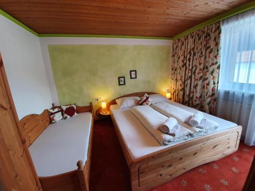a bedroom with two beds and a window at Apartment Rauch in Zell am Ziller