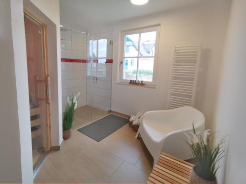 a bathroom with a shower and a toilet and a sink at Haus Elve in Zierow