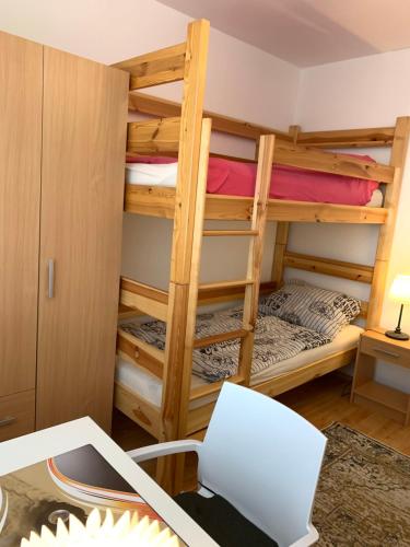 a room with two bunk beds and a desk at Apartment Botanika2 in Trnava