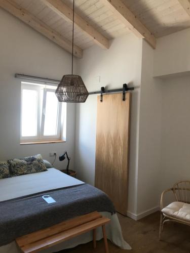 a bedroom with a bed and a pendant light at La Casita de Melón in Suances