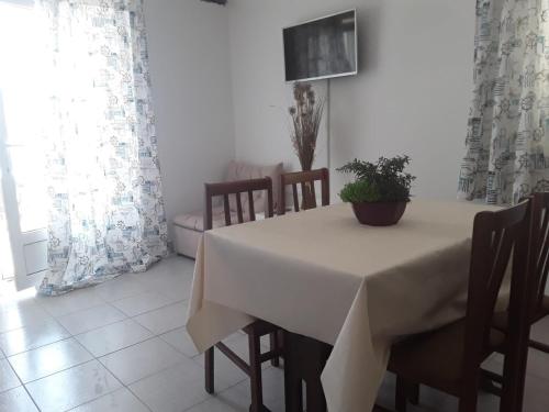 a dining room with a white table and chairs at VILLA AROMA in Pag