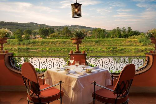 a table on a balcony with a view at Villa La Massa in Bagno a Ripoli
