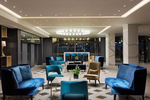 a living room filled with lots of chairs and tables at Crowne Plaza Zürich, an IHG Hotel in Zurich
