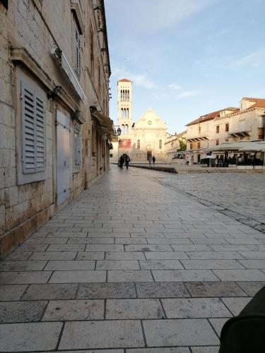 an empty street in a city with a clock tower at Villa Nora Hvar in Hvar