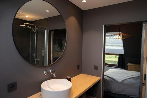 a bathroom with a sink and a mirror at Refuge des 4 As in Durbuy