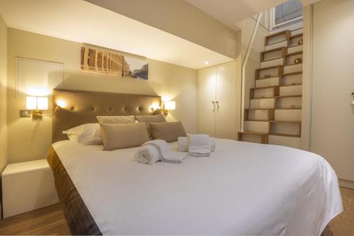 a bedroom with a large white bed with two towels on it at Duplex climatisé en Hyper Centre de Bordeaux in Bordeaux