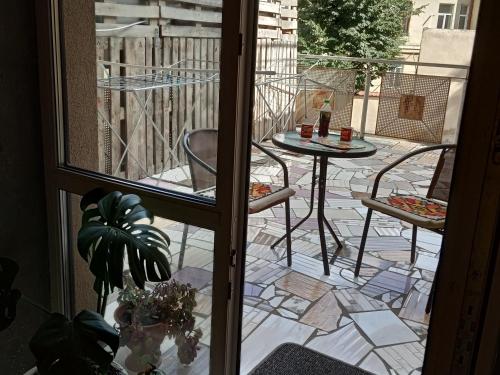 an open door to a patio with a table and chairs at Travel station in Ivano-Frankivsʼk