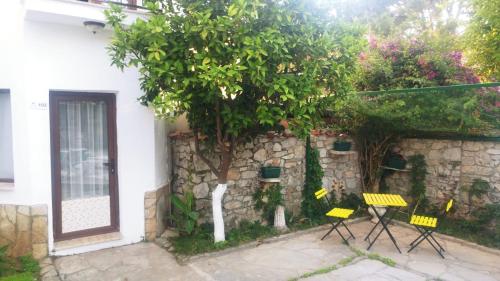 a group of chairs sitting next to a stone wall at Nehir Dalyan Boutique Otel in Ortaca