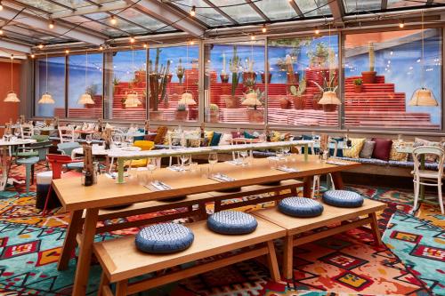 a restaurant with wooden tables in a room at Mama Shelter Marseille in Marseille