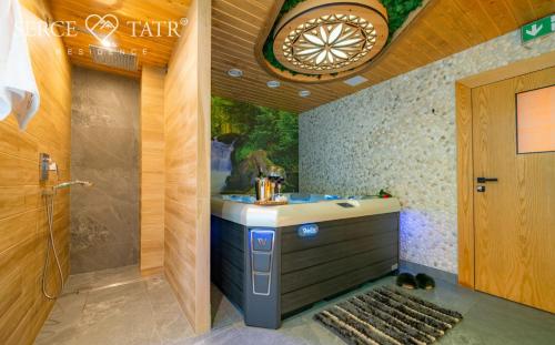 a bathroom with a sink and a shower at Serce Tatr Residence Zakopane - blisko Krupówek in Zakopane
