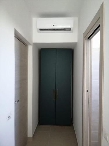a hallway with a green door in a building at Hotel Tirreno Formia in Formia