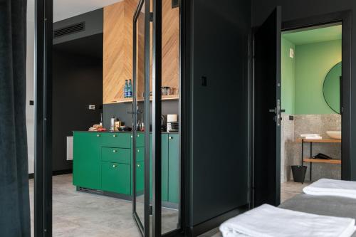 a bathroom with green cabinets and a green cabinet at TOP Garden Aparthotel in Toruń