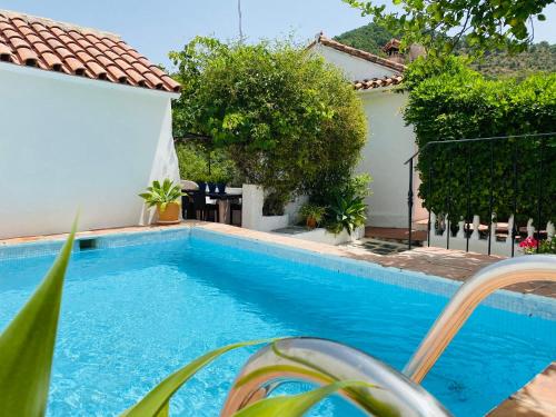 a swimming pool in front of a house at Finca Santa Ana in Ojén