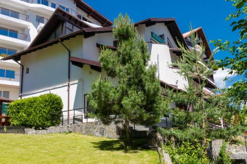 a building with trees in front of it at Vila Hera Luxury in Predeal