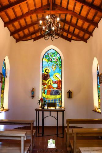 a room with a stained glass window in a church at El Pueblito Iguazú in Puerto Iguazú
