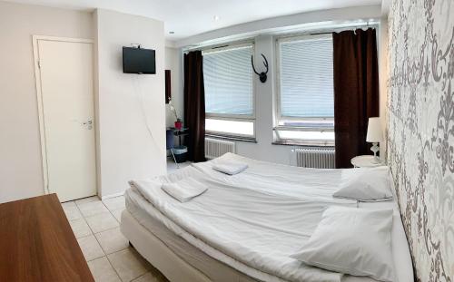 Postel nebo postele na pokoji v ubytování Hotel Harriet