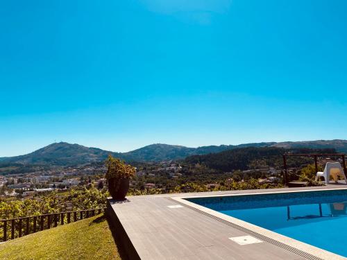 a swimming pool with a view of the mountains at Encosta do Sossego in Cabeceiras de Basto