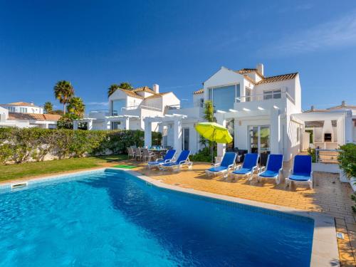 a villa with a swimming pool in front of a house at Villa Villa Blue Ocean by Interhome in Patroves