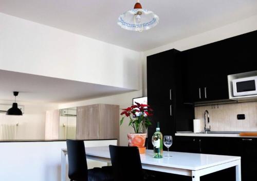 a kitchen with a table with wine glasses and flowers at LA CASA DEI NONNI in Pino Torinese