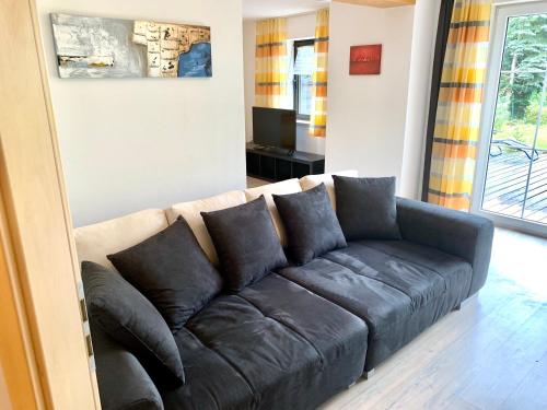 a brown couch sitting in a living room at Ferienwohnung Bielmeier in Zachenberg