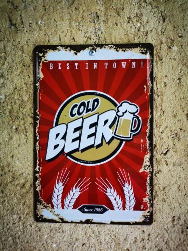a sign for cold beer attached to a wall at Hűvösvölgy Vendégház in Lókút