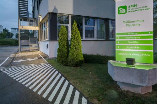 a building with a welcome sign in front of it at AMH Airport-Messe-Hotel Stuttgart in Filderstadt