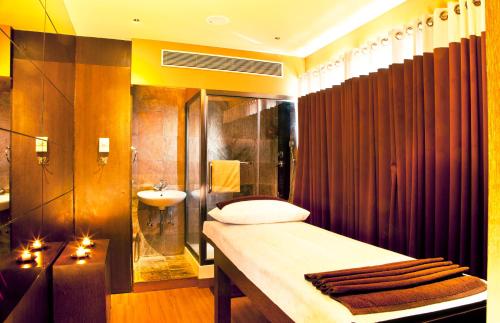 a bathroom with a tub and a sink and a shower at Octave Hotel & Spa - Sarjapur Road in Bangalore