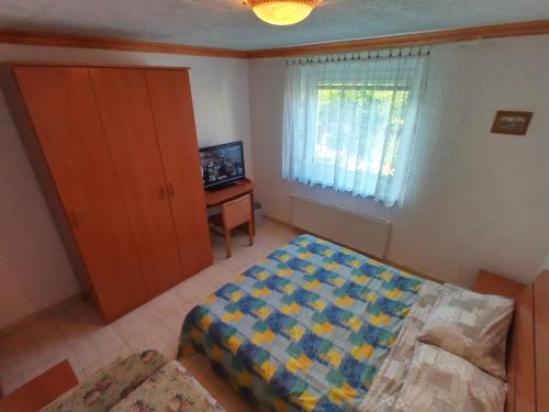 a bedroom with a bed and a television in it at ANKARAN SOBE MARA in Ankaran