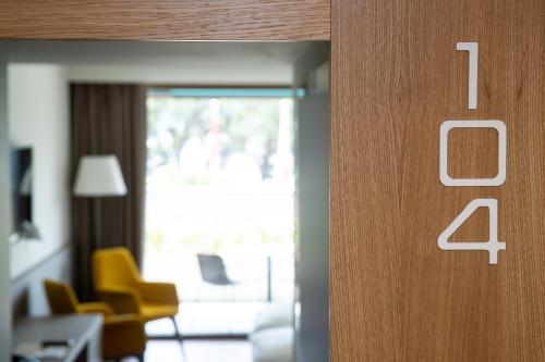 an open door to an office with a table and chairs at Hotel Lago Maggiore - Welcome! in Locarno