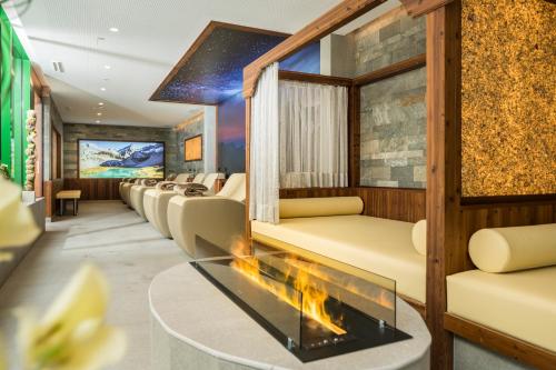 a waiting room with couches and a fireplace at Haus Oberdorf in Zams