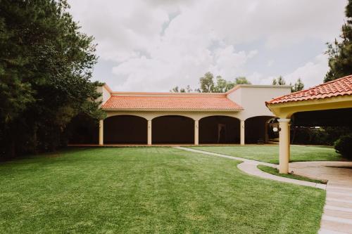 a house with a large yard with a building at Holiday Inn Durango by IHG in Durango