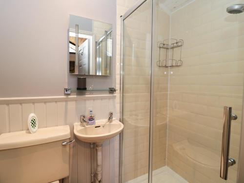 a white bathroom with a sink and a shower at Pine Tree in Newcastle upon Tyne