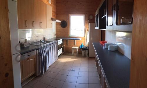 a kitchen with a black counter top in a room at Sodyba Bebrynė in Didviečiai