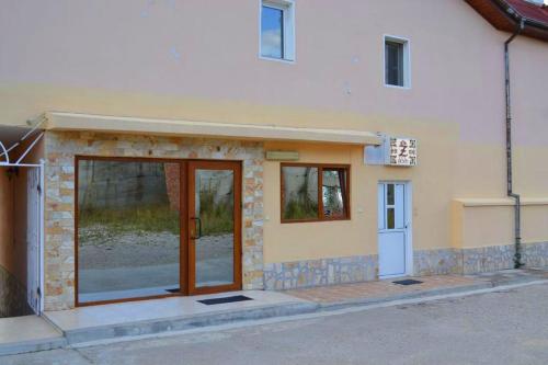 a building with a door on the side of it at Hotel Zenit Satovcha in Satovcha