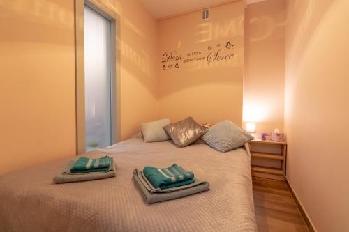a bedroom with a bed with two towels on it at Apartament Amelia in Ustrzyki Dolne
