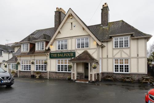 a building with a sign that reads the rainforth at Balfour Arms in Sidmouth
