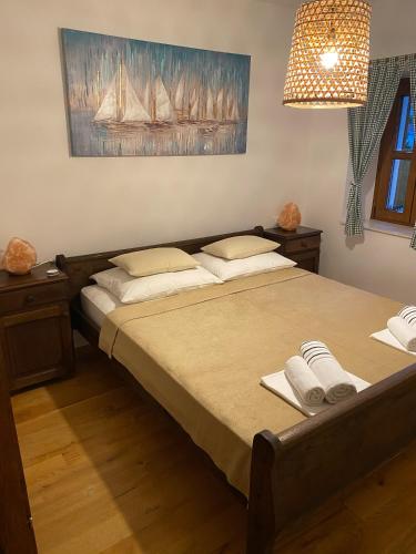 a bedroom with a bed with two towels on it at Villa Charles in Trogir