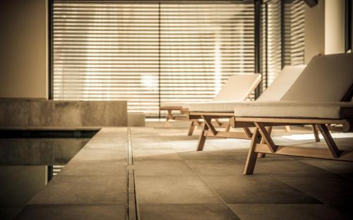 a row of white beds sitting in a room at Agritur Renetta in Tassullo